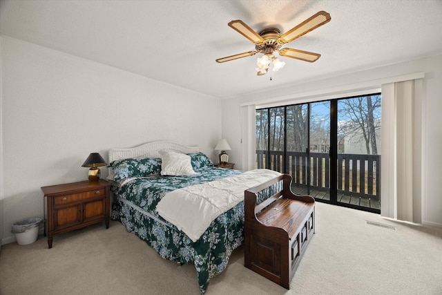 bedroom with light carpet, visible vents, a ceiling fan, access to outside, and a textured ceiling