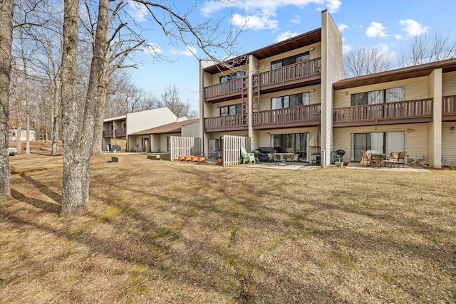 back of property with a patio and a lawn