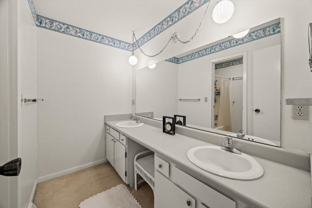 full bath with double vanity, shower / bath combo, a sink, and baseboards