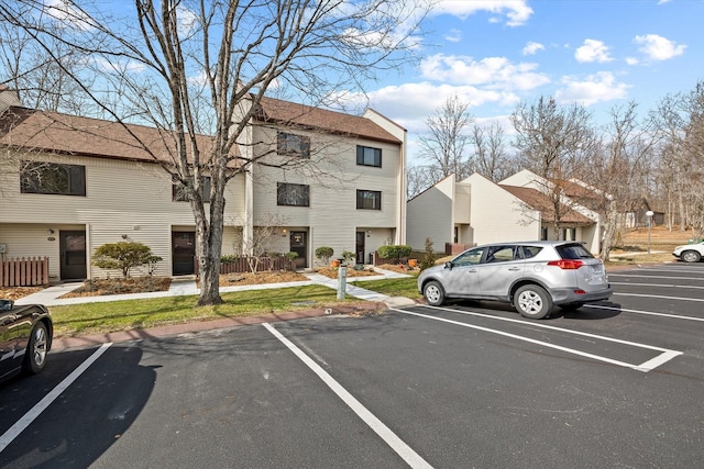 uncovered parking lot with a residential view