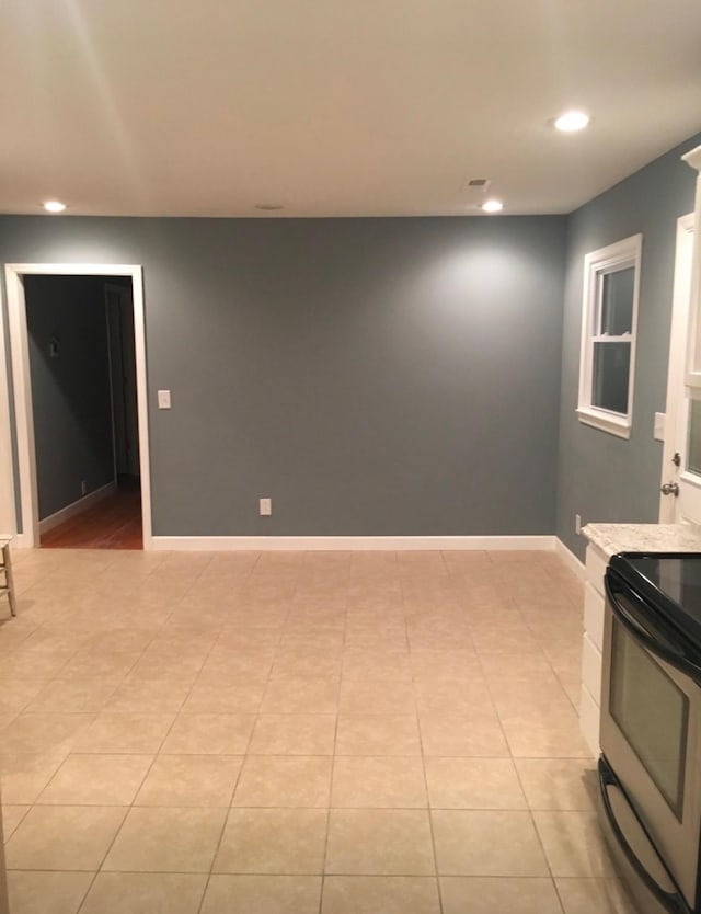 interior space featuring light tile patterned floors, recessed lighting, and baseboards