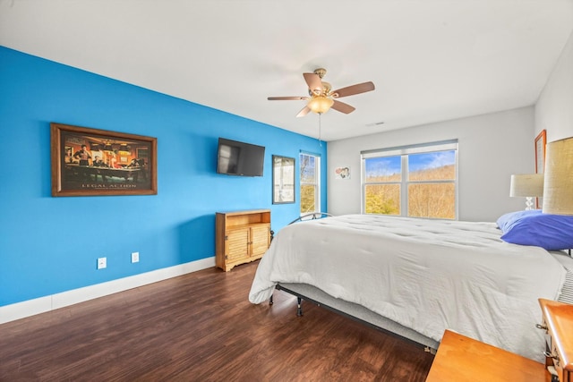 bedroom featuring ceiling fan, baseboards, and dark wood-type flooring