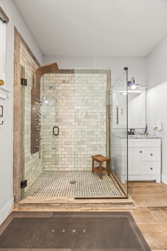 bathroom with a stall shower and vanity