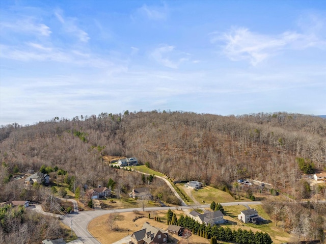 drone / aerial view featuring a wooded view