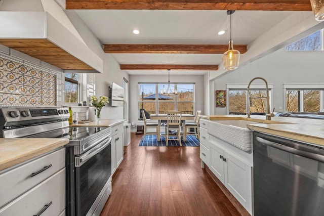 kitchen with electric range, white cabinetry, light countertops, dishwasher, and pendant lighting