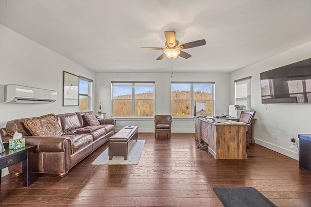 living room with an AC wall unit, dark wood finished floors, and a healthy amount of sunlight