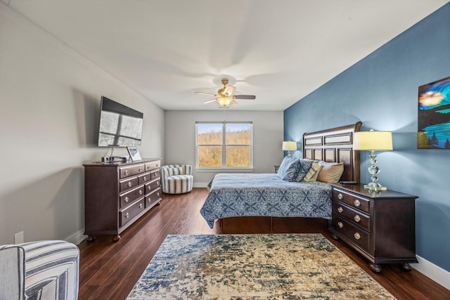 bedroom featuring a ceiling fan, heating unit, dark wood finished floors, and baseboards