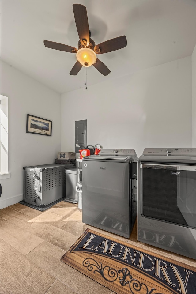 laundry area featuring laundry area, electric panel, washer and clothes dryer, and baseboards