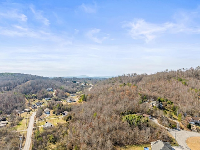 birds eye view of property featuring a view of trees