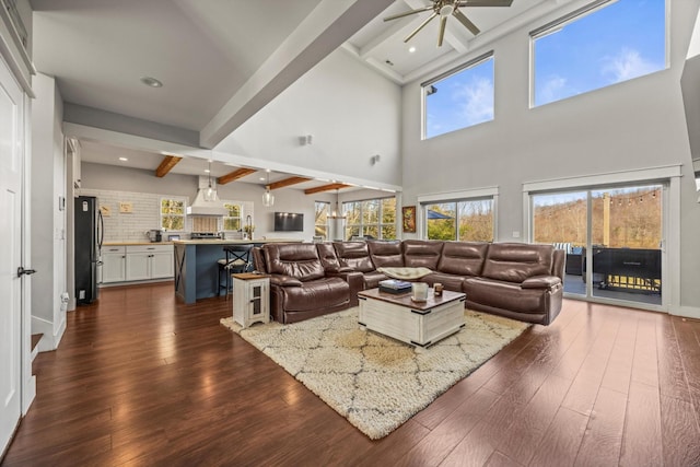 living room featuring dark wood-type flooring, recessed lighting, beamed ceiling, and a ceiling fan