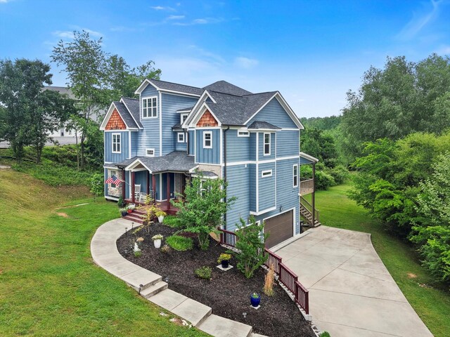 craftsman inspired home featuring concrete driveway, a garage, a porch, and a front lawn