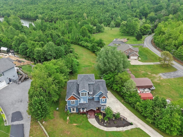 birds eye view of property with a view of trees