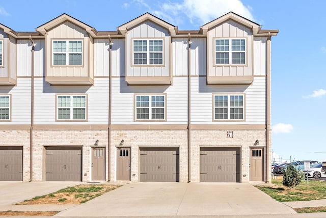 multi unit property with a garage, board and batten siding, and driveway