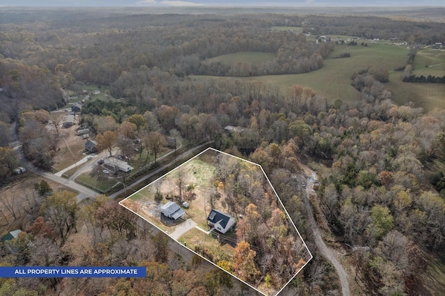 bird's eye view featuring a wooded view