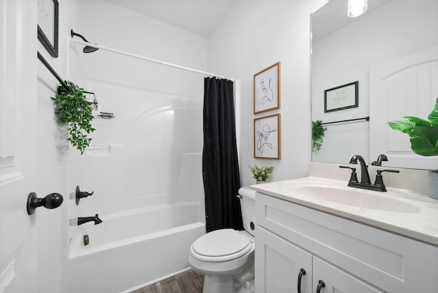 bathroom featuring shower / bath combo, vanity, toilet, and wood finished floors