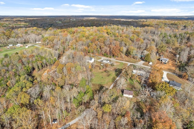 bird's eye view with a wooded view