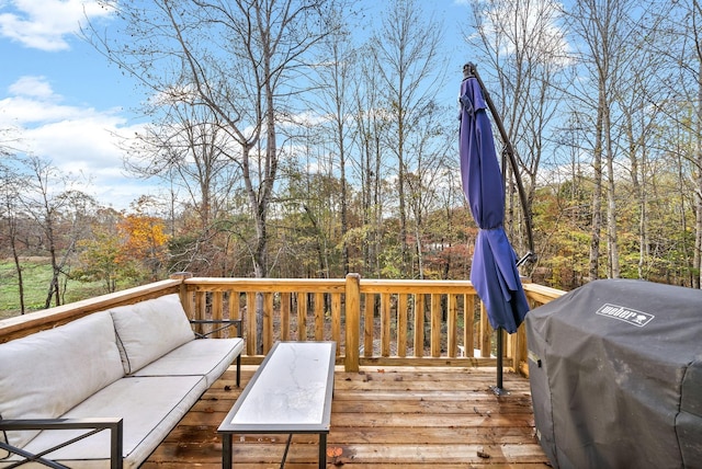 wooden terrace with grilling area and an outdoor living space