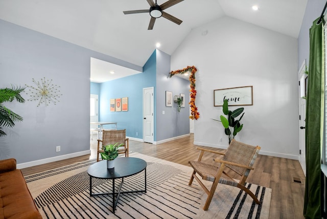 living area featuring light wood-style floors, baseboards, visible vents, and a ceiling fan