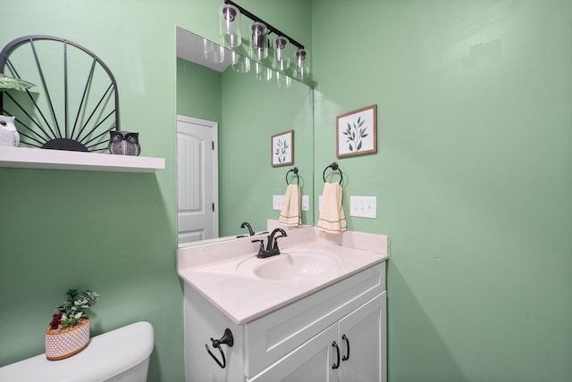 bathroom featuring toilet and vanity