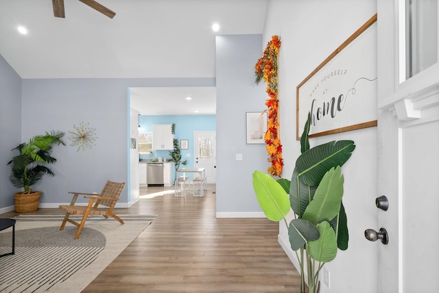 foyer entrance with a ceiling fan, recessed lighting, baseboards, and wood finished floors