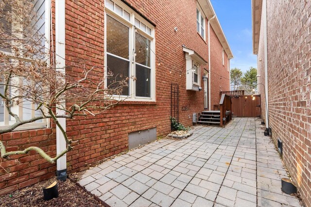 505 Wilcox St, Clarksville, TN 37040 - view of side of home with a patio, brick siding, crawl space, and fence