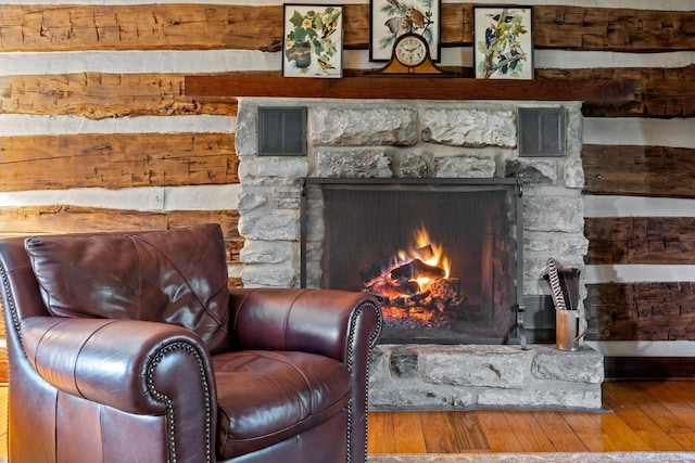 interior space featuring visible vents, a fireplace, and wood finished floors