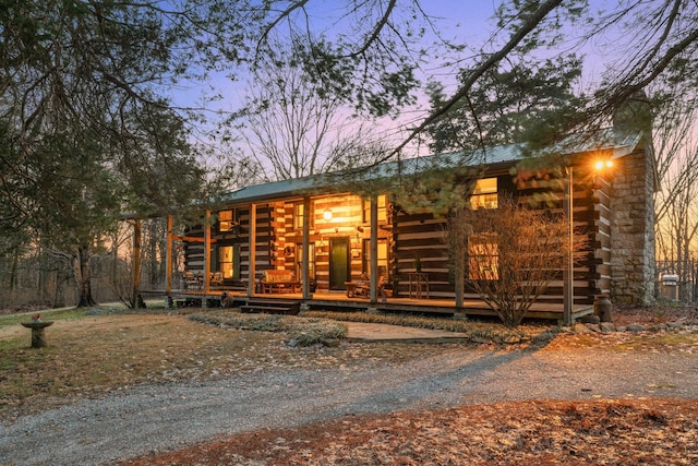 cabin featuring metal roof and log exterior