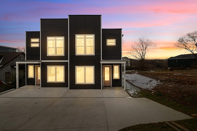 back of property featuring a patio area and board and batten siding