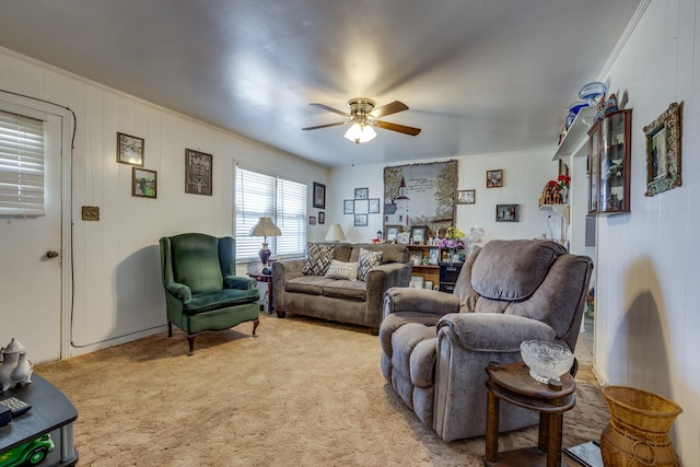 living room featuring a ceiling fan, light colored carpet, and ornamental molding