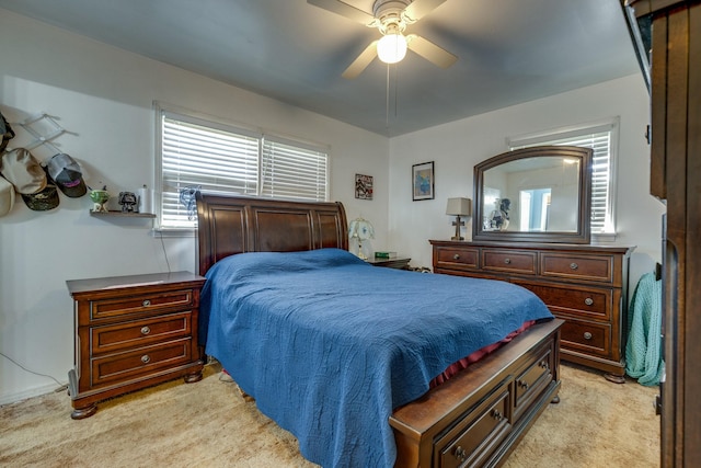 bedroom with a ceiling fan and light carpet