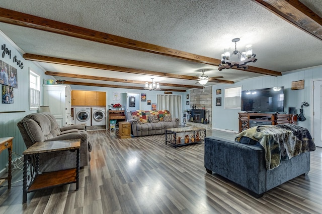 living area featuring a textured ceiling, beamed ceiling, wood finished floors, and washer and dryer