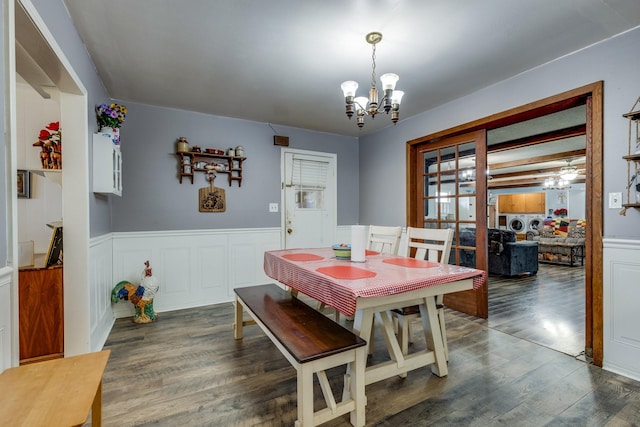 dining space featuring a wainscoted wall, a chandelier, and wood finished floors