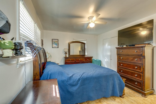 bedroom with ceiling fan and a closet