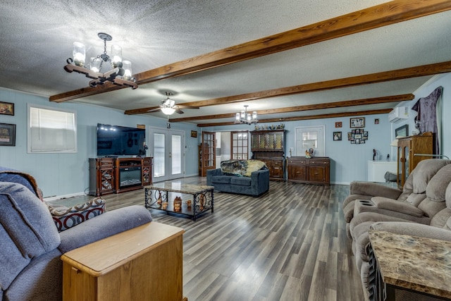 living area with a textured ceiling, wood finished floors, a notable chandelier, and a wall mounted AC