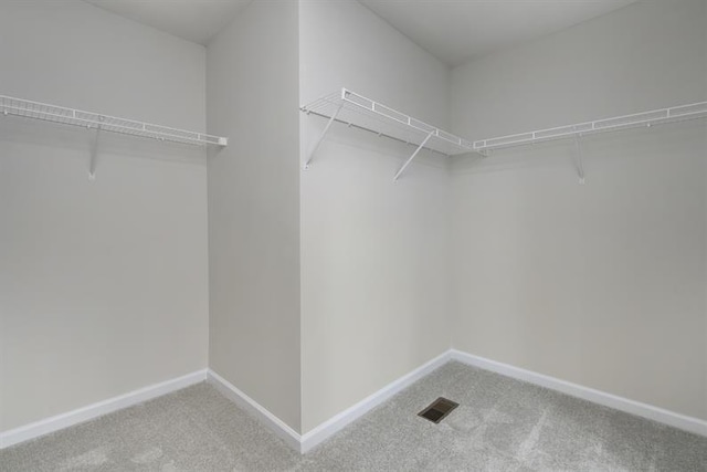 spacious closet with visible vents and carpet flooring