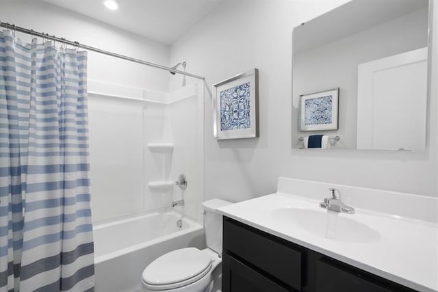 bathroom with toilet, shower / tub combo, and vanity