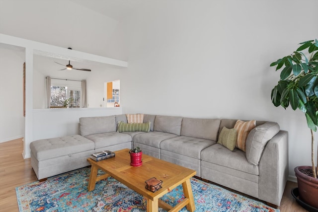 living area with light wood-style flooring and a ceiling fan