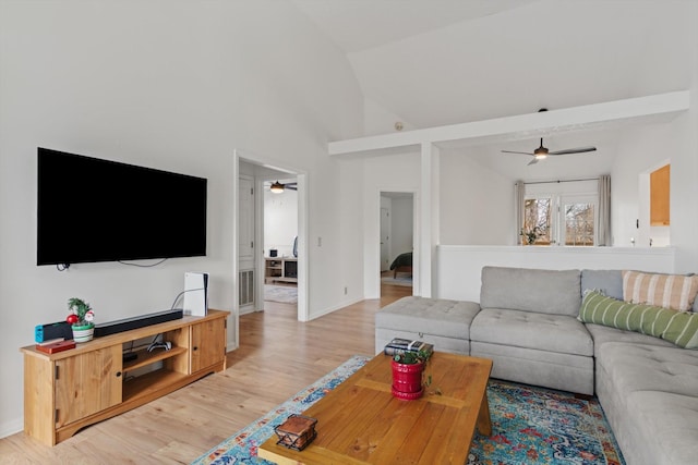 living room with light wood-style floors, ceiling fan, visible vents, and vaulted ceiling