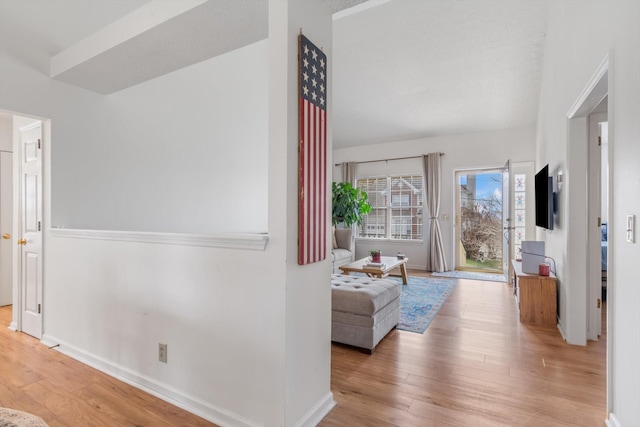 interior space featuring baseboards and wood finished floors