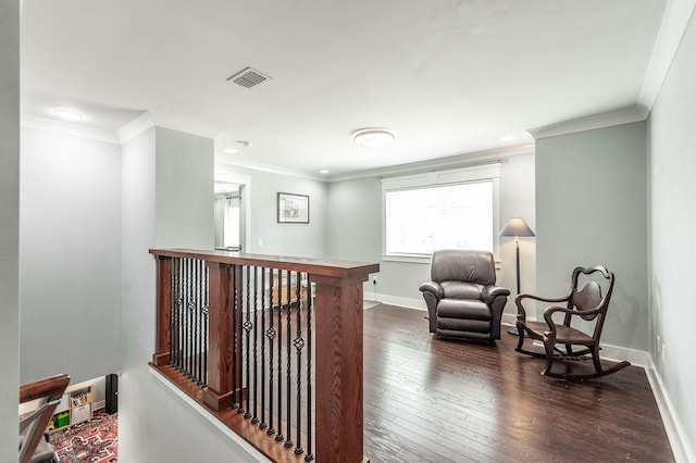 hall featuring dark wood-type flooring, baseboards, visible vents, and crown molding