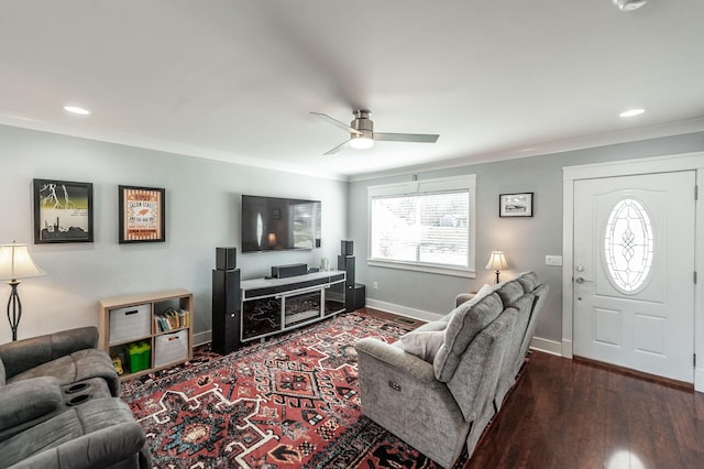 living area featuring a ceiling fan, ornamental molding, and dark wood finished floors