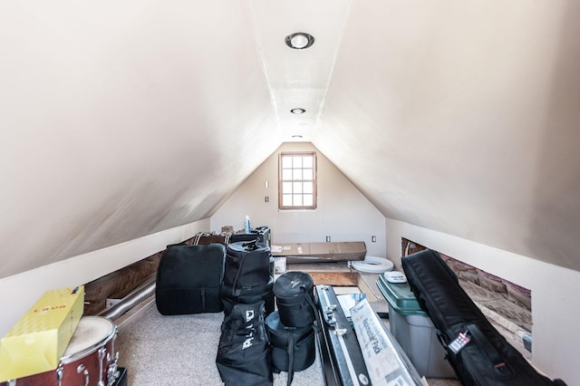 carpeted office featuring lofted ceiling