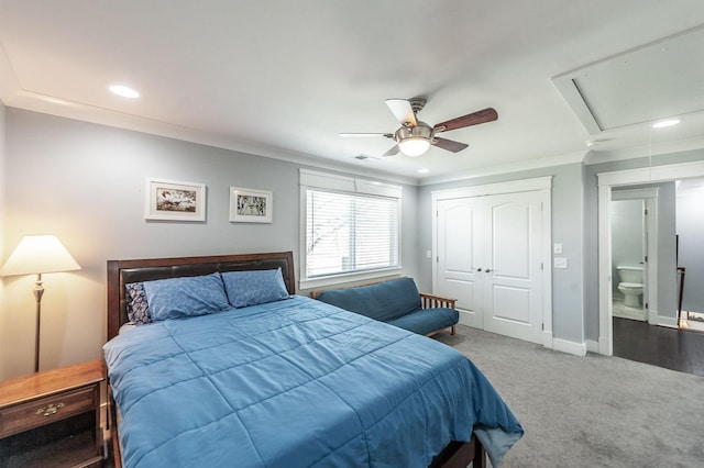 bedroom featuring carpet flooring, ornamental molding, baseboards, visible vents, and a closet