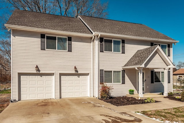 view of front of home featuring a garage, roof with shingles, and driveway