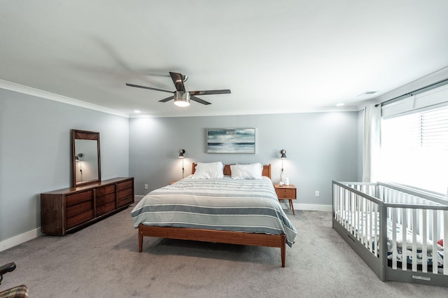 bedroom featuring crown molding, baseboards, visible vents, ceiling fan, and carpet