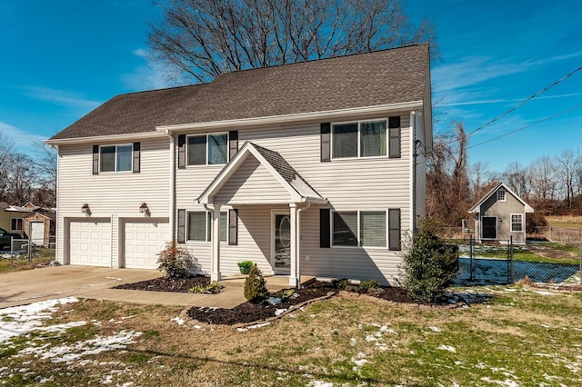 view of front of house featuring concrete driveway, roof with shingles, an attached garage, fence, and a front lawn