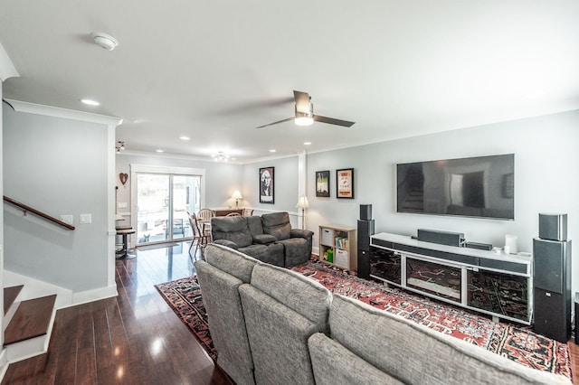 living area featuring baseboards, stairs, ceiling fan, ornamental molding, and wood-type flooring