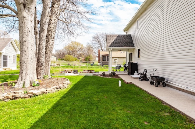 view of yard with fence and a patio