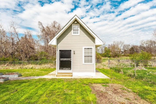 view of outdoor structure featuring a garden, a fenced backyard, and entry steps