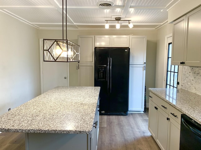 kitchen featuring a kitchen island, white cabinets, hanging light fixtures, light stone countertops, and black appliances